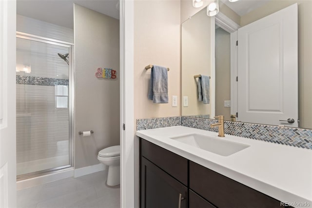 bathroom with vanity, tile patterned floors, toilet, and a shower stall