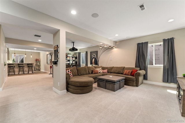living area featuring bar, visible vents, light colored carpet, baseboards, and recessed lighting