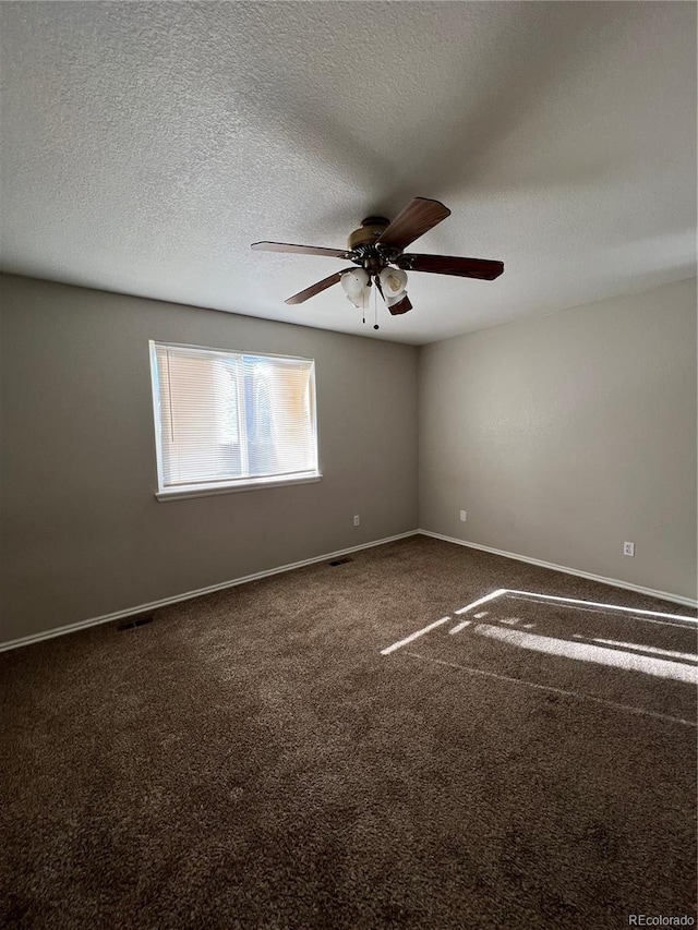 carpeted spare room with ceiling fan and a textured ceiling