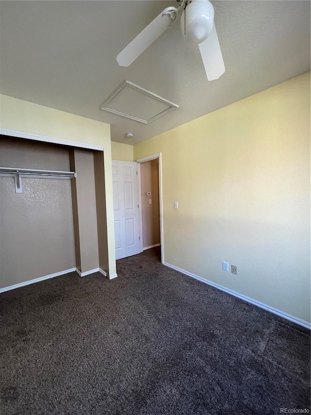 unfurnished bedroom featuring a closet, dark carpet, and ceiling fan