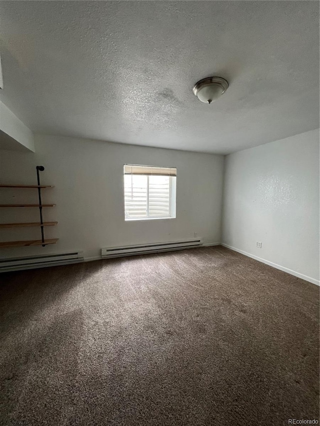 unfurnished room with a textured ceiling, dark carpet, and baseboard heating