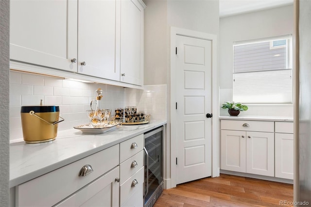 4142 Saltbrush Ct, Loveland, CO 80538 - indoor dry bar featuring wine cooler, light wood-style flooring, and decorative backsplash