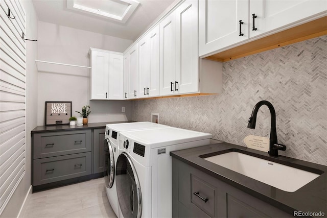 4142 Saltbrush Ct, Loveland, CO 80538 - laundry area featuring cabinet space, washer and dryer, and light tile patterned flooring