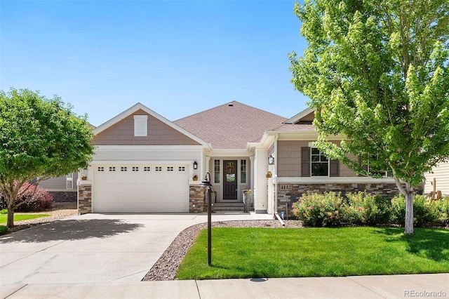 4142 Saltbrush Ct, Loveland, CO 80538 - view of front facade with stone siding, an attached garage, a front yard, and driveway