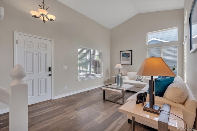 9884 Sydney Ln, Highlands Ranch, CO 80130 - living area with high vaulted ceiling, wood finished floors, baseboards, and a chandelier
