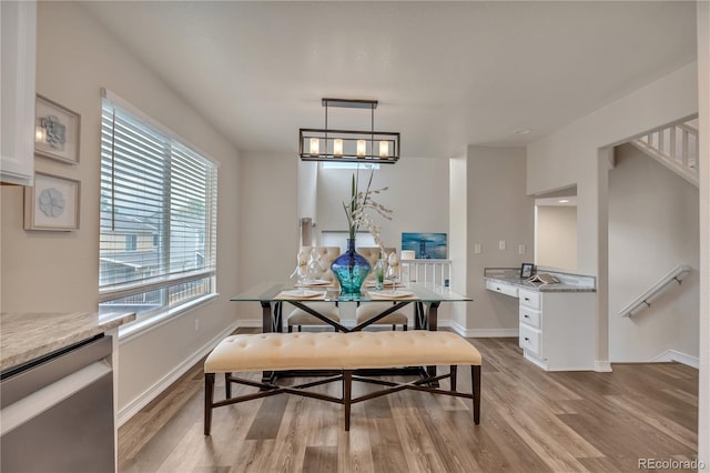 9884 Sydney Ln, Highlands Ranch, CO 80130 - dining space with light wood-type flooring, baseboards, and stairs