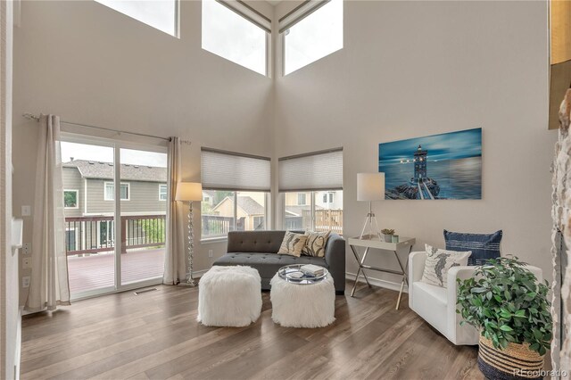 9884 Sydney Ln, Highlands Ranch, CO 80130 - living area featuring wood finished floors and a towering ceiling