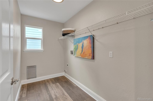 9884 Sydney Ln, Highlands Ranch, CO 80130 - washroom featuring hookup for a washing machine, hookup for an electric dryer, wood finished floors, and baseboards