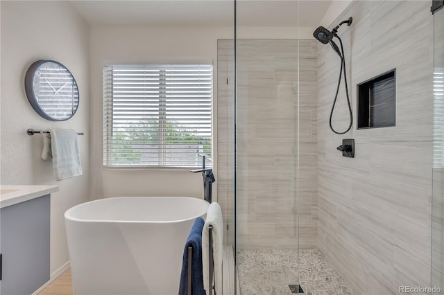 9884 Sydney Ln, Highlands Ranch, CO 80130 - bathroom with a stall shower, a freestanding tub, and vanity