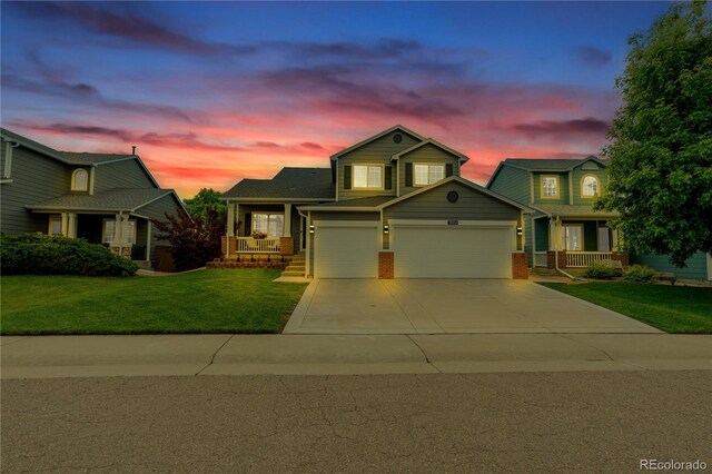 9884 Sydney Ln, Highlands Ranch, CO 80130 - view of front of property featuring covered porch, a yard, concrete driveway, brick siding, and an attached garage