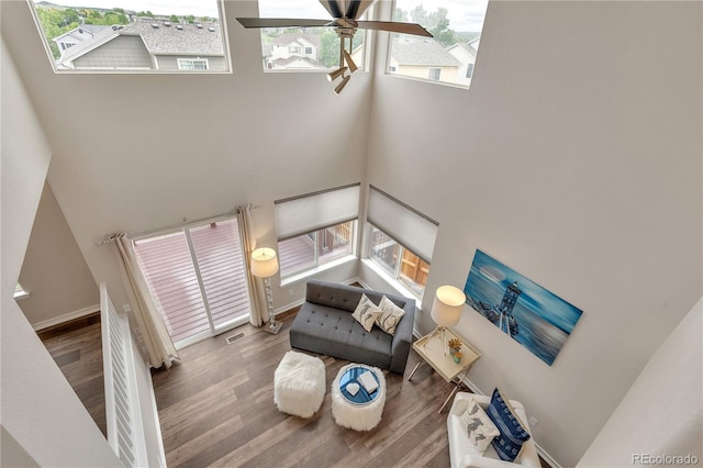 9884 Sydney Ln, Highlands Ranch, CO 80130 - living area featuring a high ceiling, wood finished floors, ceiling fan, and baseboards