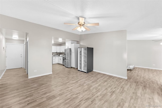 unfurnished living room with light wood-type flooring and ceiling fan