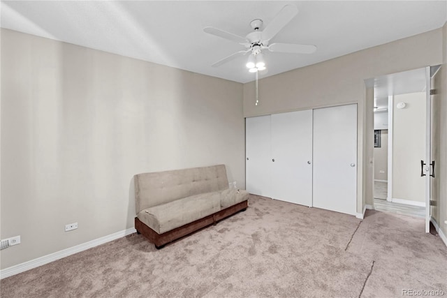 living area featuring ceiling fan and light carpet