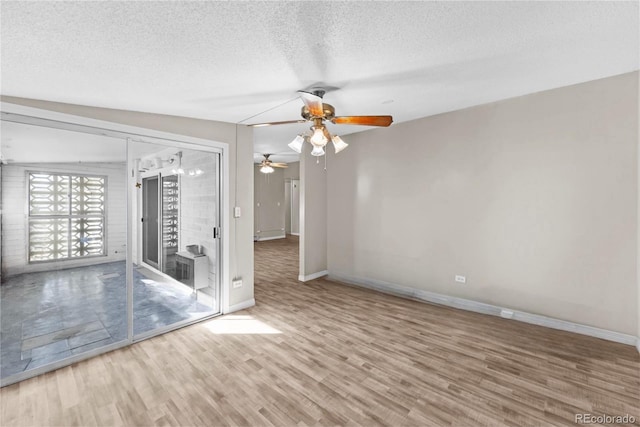 unfurnished room featuring wood-type flooring, a textured ceiling, vaulted ceiling, and ceiling fan