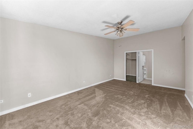 unfurnished bedroom featuring carpet, a closet, a spacious closet, and ceiling fan