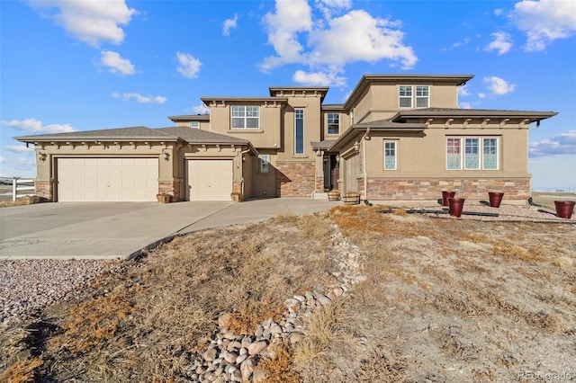 view of front of home with stucco siding, stone siding, a garage, and driveway