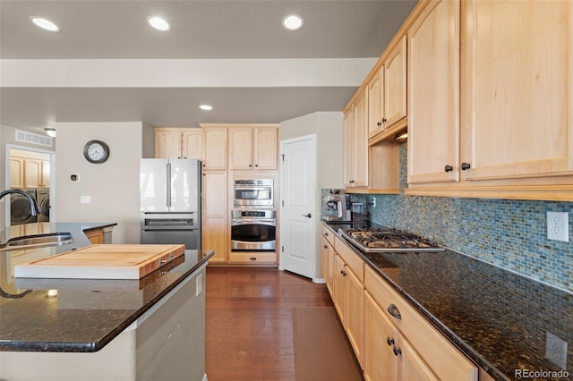 kitchen featuring a sink, stainless steel appliances, visible vents, and light brown cabinetry