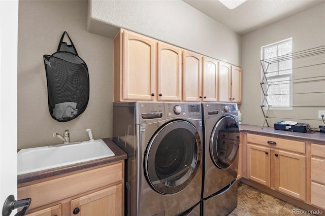 laundry room featuring a sink, cabinet space, and washer and clothes dryer