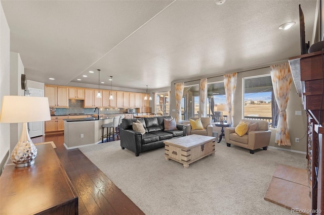 living room with recessed lighting, dark wood-type flooring, and baseboards