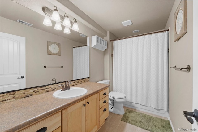 full bath with visible vents, toilet, shower / tub combo, decorative backsplash, and vanity