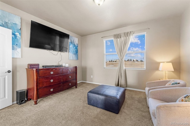 sitting room featuring carpet and baseboards