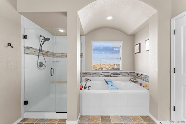 bathroom with a bath and a shower stall