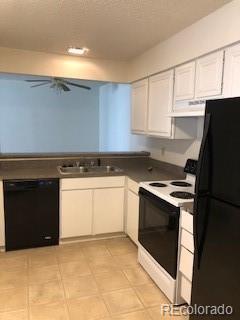 2355 E Geddes Ave Unit G24, Centennial, CO 80122 - kitchen with black appliances, exhaust hood, white cabinets, and dark countertops