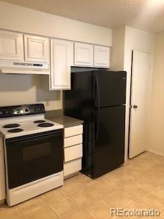 2355 E Geddes Ave Unit G24, Centennial, CO 80122 - kitchen with electric range, freestanding refrigerator, under cabinet range hood, and white cabinets