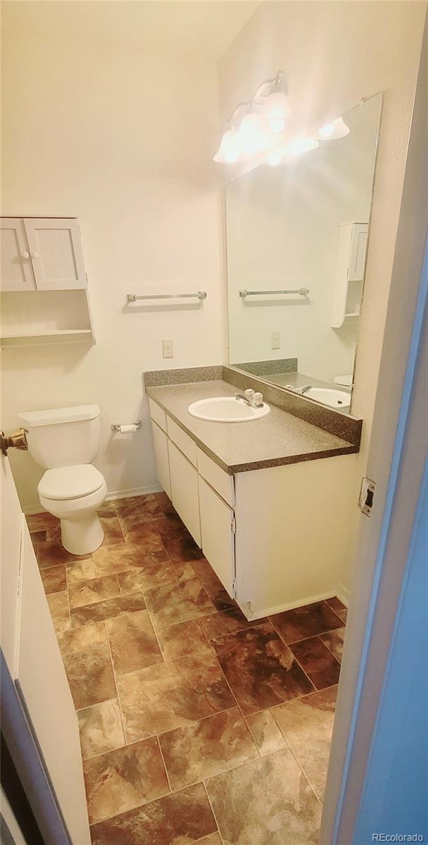 2355 E Geddes Ave Unit G24, Centennial, CO 80122 - bathroom with vanity and stone finish floors