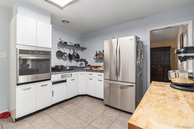 400 W Midway Blvd, Broomfield, CO 80020 - kitchen with appliances with stainless steel finishes, open shelves, light tile patterned floors, white cabinets, and wooden counters