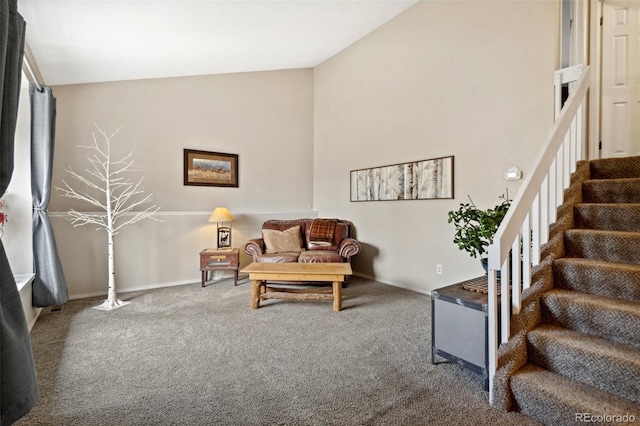 carpeted living area with baseboards, high vaulted ceiling, and stairway