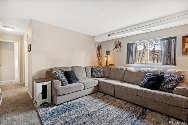 carpeted living area featuring baseboards and visible vents