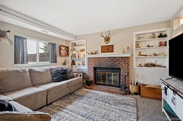 carpeted living room with a textured ceiling, built in features, a fireplace, and visible vents