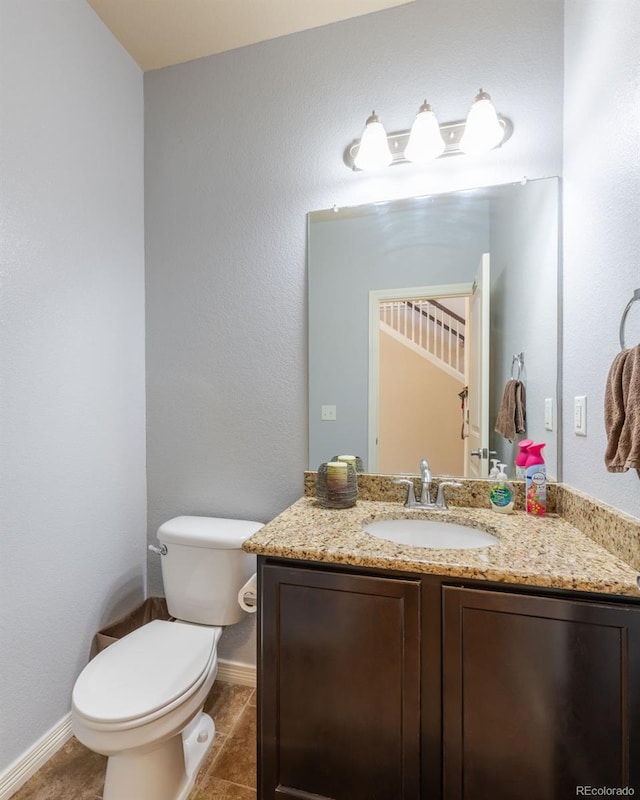 bathroom with tile patterned floors, vanity, and toilet