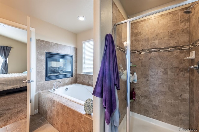 bathroom featuring tile patterned floors and separate shower and tub