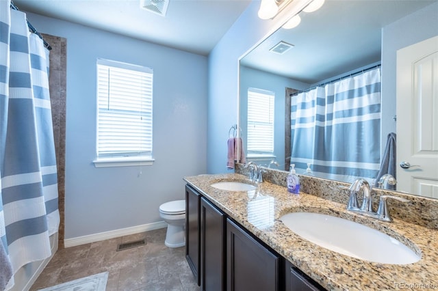 bathroom featuring a shower with curtain, plenty of natural light, vanity, and toilet