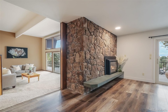 living room featuring hardwood / wood-style flooring and beam ceiling