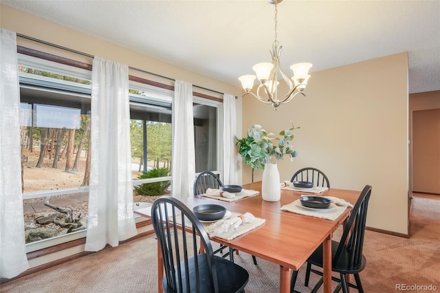 carpeted dining space featuring a notable chandelier