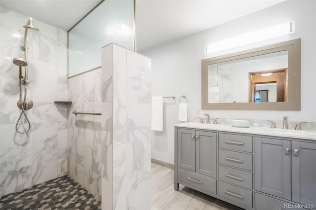 bathroom featuring vanity and tiled shower