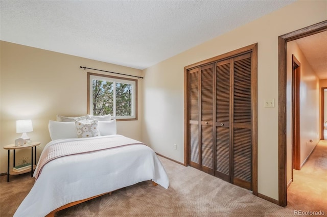 bedroom featuring a closet, a textured ceiling, and carpet