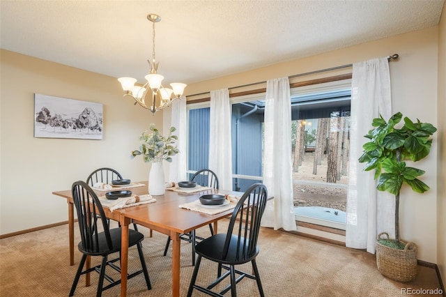 carpeted dining area with an inviting chandelier and a textured ceiling