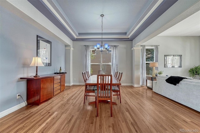 581 Stonemont Dr, Castle Pines, CO 80108 - dining room with a chandelier, a raised ceiling, light wood-style floors, healthy amount of natural light, and ornamental molding