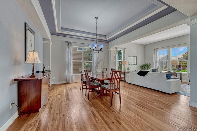 581 Stonemont Dr, Castle Pines, CO 80108 - dining space featuring a raised ceiling, light wood-type flooring, baseboards, and a chandelier