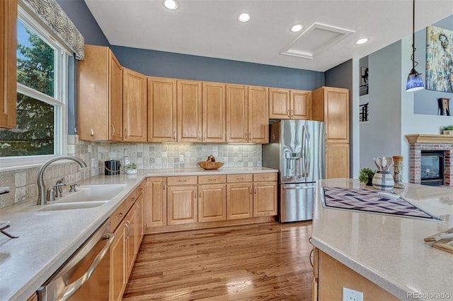 581 Stonemont Dr, Castle Pines, CO 80108 - kitchen with stainless steel appliances, a sink, light countertops, light wood-style flooring, and recessed lighting
