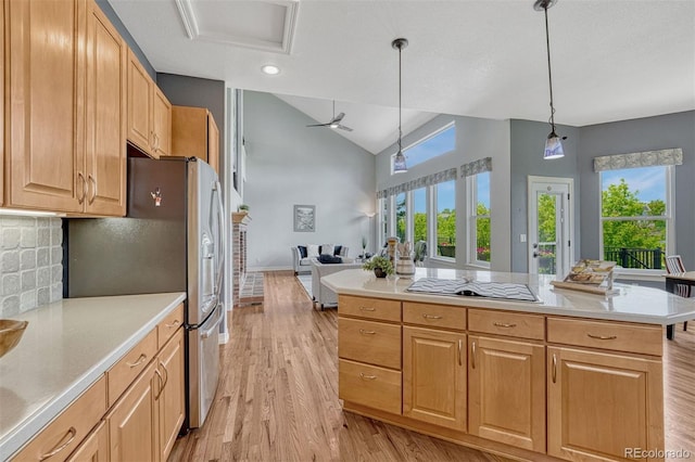 581 Stonemont Dr, Castle Pines, CO 80108 - kitchen featuring black electric stovetop, light wood-style floors, stainless steel refrigerator with ice dispenser, light countertops, and decorative backsplash