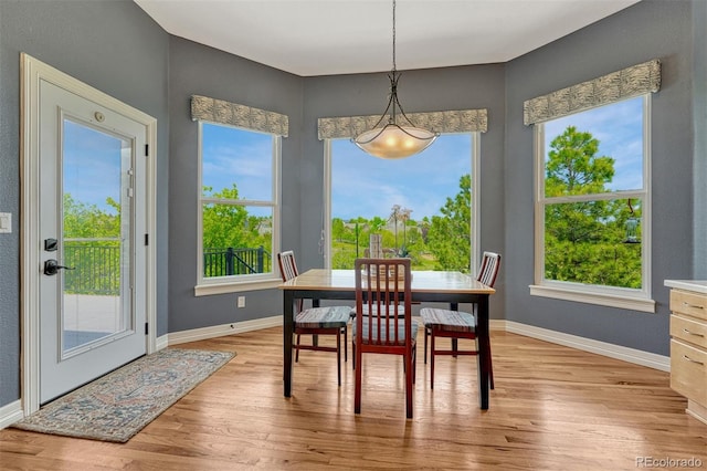581 Stonemont Dr, Castle Pines, CO 80108 - dining room with light wood finished floors, baseboards, and plenty of natural light