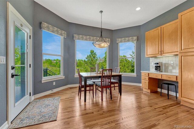 581 Stonemont Dr, Castle Pines, CO 80108 - dining space featuring light wood-style floors, baseboards, recessed lighting, and a desk