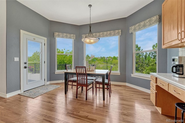 581 Stonemont Dr, Castle Pines, CO 80108 - dining room featuring plenty of natural light, baseboards, and light wood finished floors