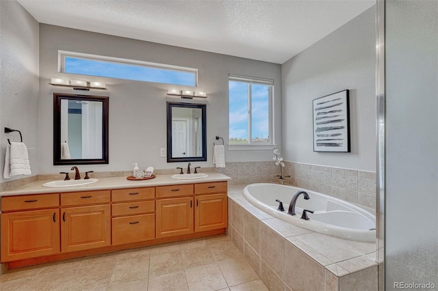581 Stonemont Dr, Castle Pines, CO 80108 - full bathroom featuring a bath, double vanity, a textured ceiling, and tile patterned flooring