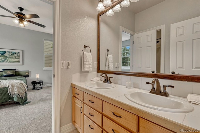 581 Stonemont Dr, Castle Pines, CO 80108 - ensuite bathroom with double vanity, a ceiling fan, and baseboards